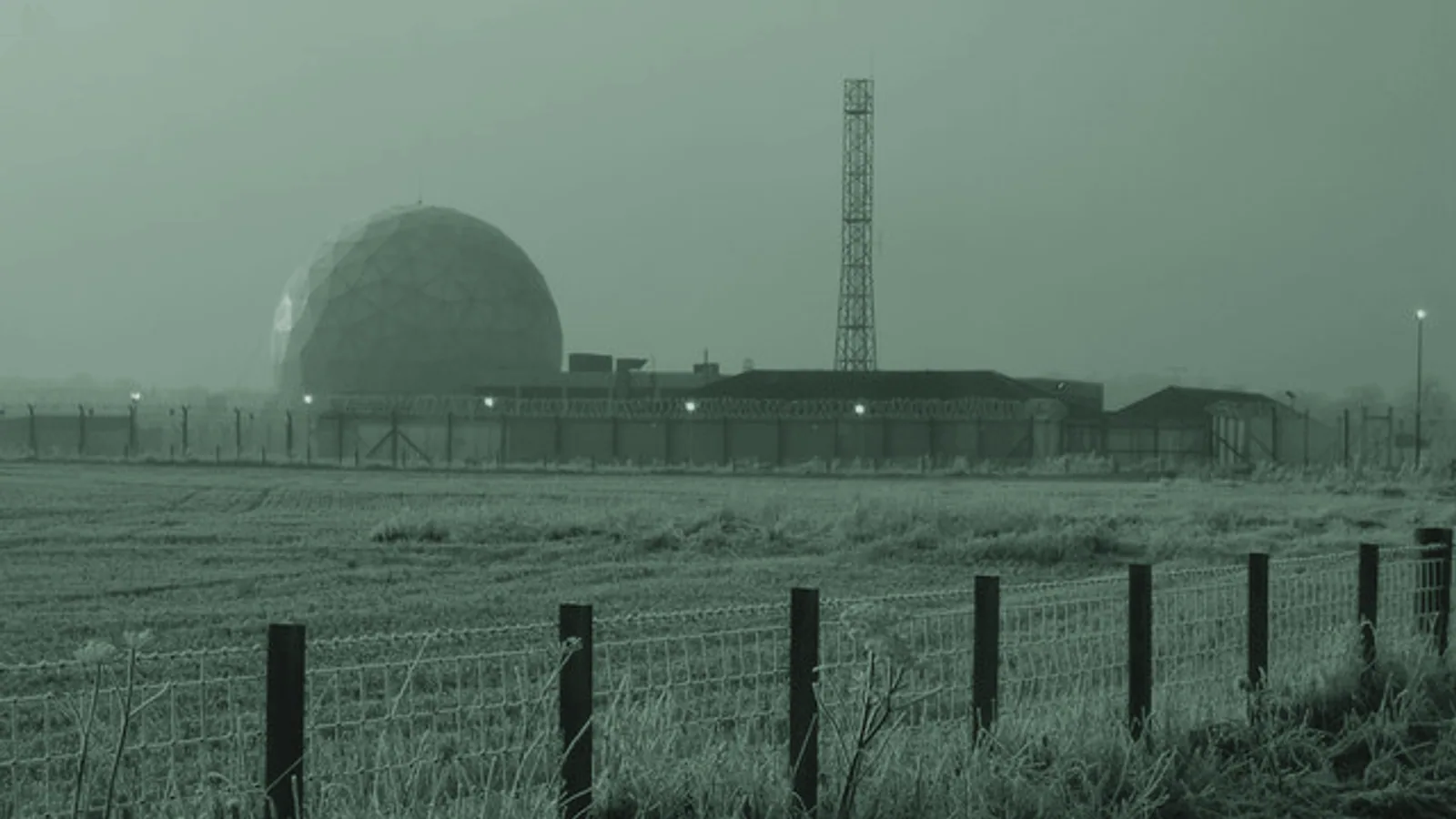 A satellite ground station and communications infrastructure in a frosty landscape.