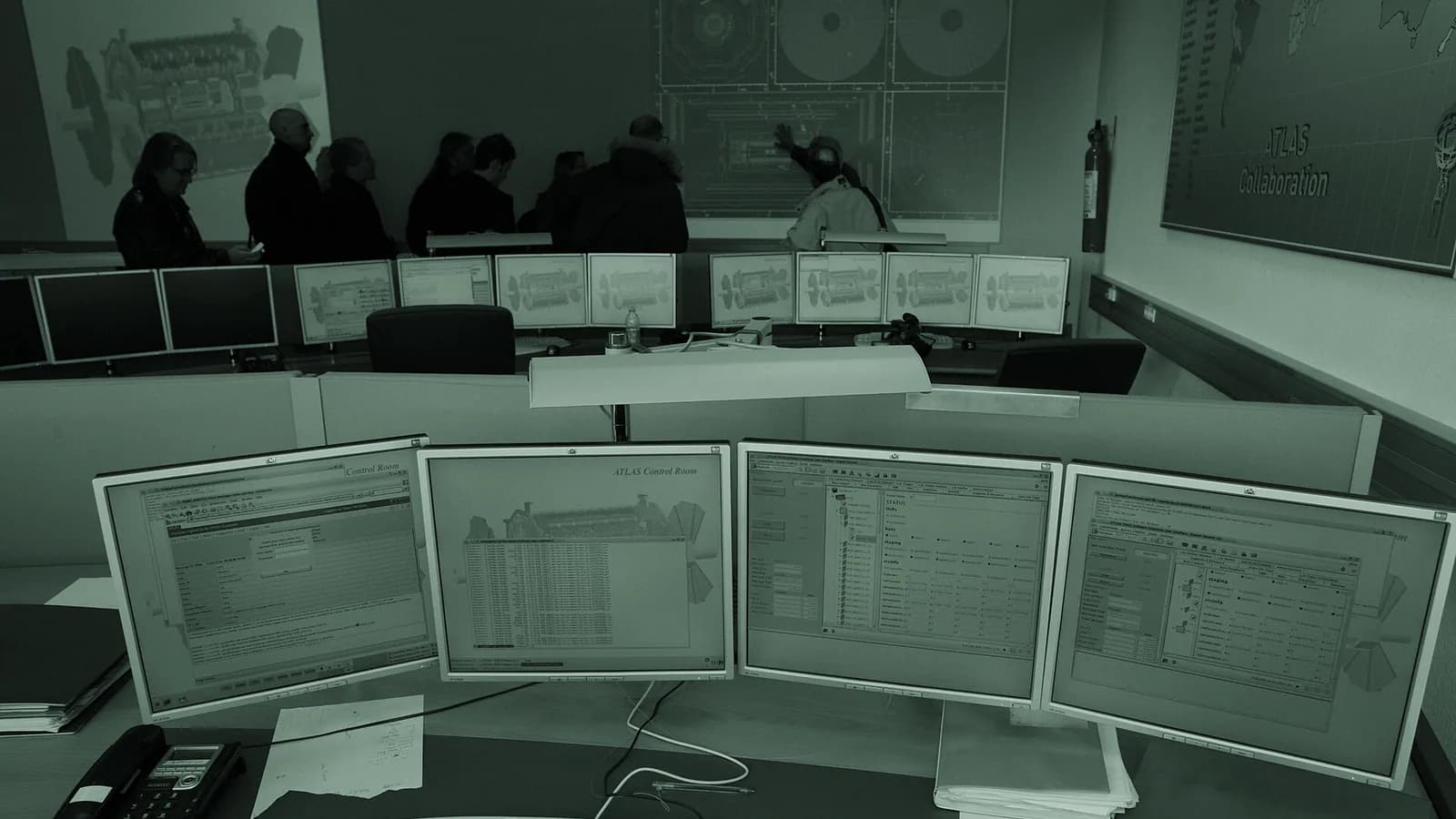A CERN control room with several monitoring screens and operator desks.