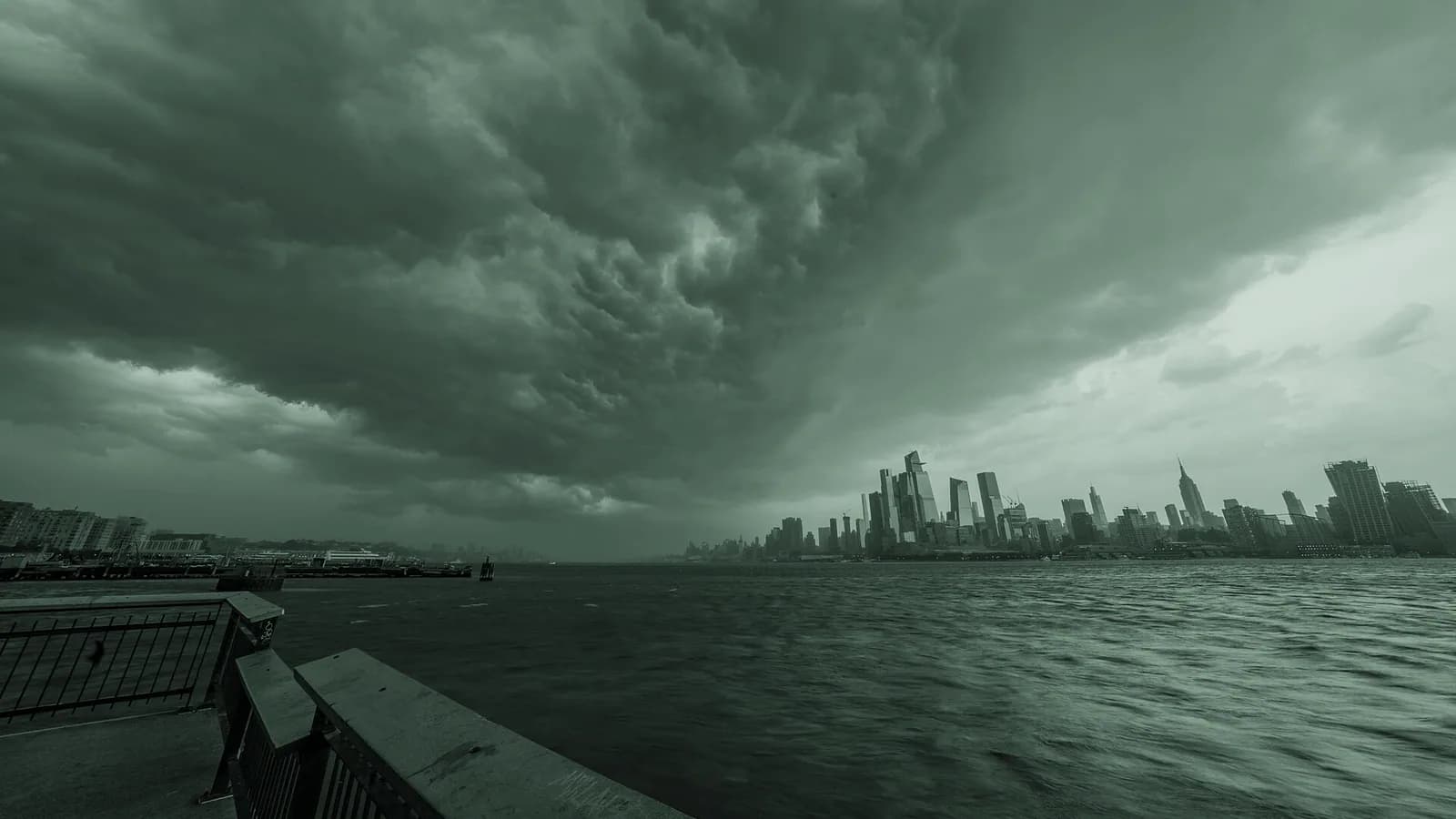 Dark storm clouds gathering over the New York City skyline.