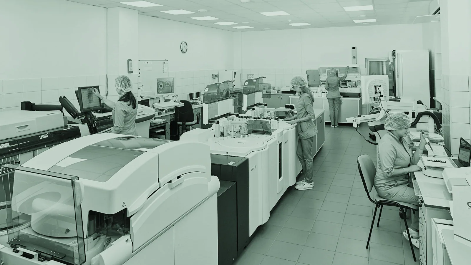 Scientists working together in a laboratory with analytical equipment.