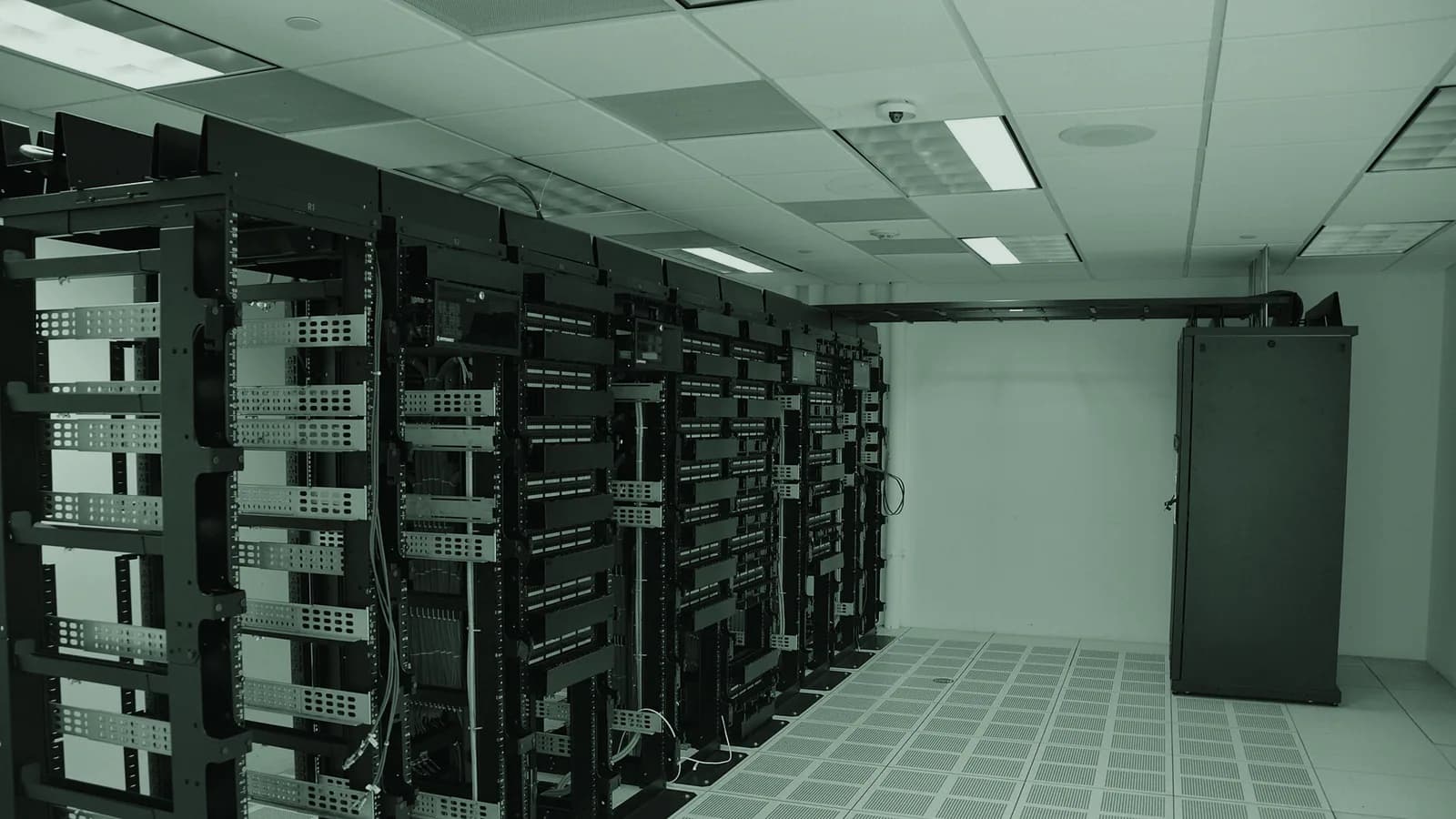 Rows of physical server racks inside a data center.